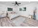 Bright bedroom with plush rug, hardwood-style floors, and natural light from large windows at 1873 Murray Ave, Clearwater, FL 33755