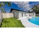 A backyard pool features pristine coping and two sets of metal ladders for easy access at 1873 Murray Ave, Clearwater, FL 33755