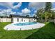 A backyard pool provides a refreshing retreat with ample deck space and outdoor lighting at 1873 Murray Ave, Clearwater, FL 33755