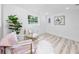 Bright sitting room with white walls, stylish chairs, and hardwood-style floors at 1873 Murray Ave, Clearwater, FL 33755