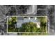 Aerial shot showing roof of home surrounded by mature trees, in Tampa, FL at 213 N Hesperides St, Tampa, FL 33609