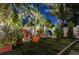 Inviting backyard featuring colorful Adirondack chairs and lush landscaping, perfect for outdoor relaxation at 213 N Hesperides St, Tampa, FL 33609