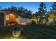This serene backyard features a jacuzzi under a pergola, lounge area, and a well-manicured lawn at 213 N Hesperides St, Tampa, FL 33609