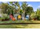 Relax in this green backyard with colorful chairs and a modern white fence that creates a welcoming space at 213 N Hesperides St, Tampa, FL 33609