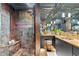 Modern bathroom with double sinks, walk-in shower, stone walls, and ample counter space at 213 N Hesperides St, Tampa, FL 33609