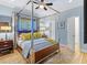 Stylish bedroom with a four-poster bed, modern furnishings, and natural light at 213 N Hesperides St, Tampa, FL 33609