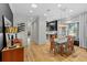 Dining room with a glass table, modern chandelier, and wood floors at 213 N Hesperides St, Tampa, FL 33609