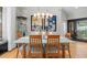 Bright dining area with art, glass table, wood chairs, and natural light at 213 N Hesperides St, Tampa, FL 33609