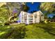 Charming home featuring a welcoming front porch, lush lawn, and mature trees illuminated at night at 213 N Hesperides St, Tampa, FL 33609