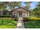 Inviting home with a stone walkway, manicured landscaping, and a cozy front porch at 213 N Hesperides St, Tampa, FL 33609