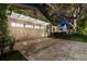 Attached garage with automatic door, beautiful stone paved driveway, and vine-covered pergola at 213 N Hesperides St, Tampa, FL 33609