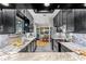 Gourmet kitchen featuring sleek black cabinets, granite countertops, and stainless steel appliances at 213 N Hesperides St, Tampa, FL 33609