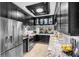 Modern kitchen with black cabinets, granite countertops, and stainless steel appliances at 213 N Hesperides St, Tampa, FL 33609