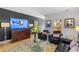 Cozy living room featuring stylish furniture, a modern TV, and hardwood floors at 213 N Hesperides St, Tampa, FL 33609