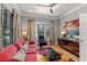 Comfortable living room with bay window, ceiling fan, and hardwood floors at 213 N Hesperides St, Tampa, FL 33609
