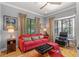 Cozy living room features a bay window, plush seating, and natural light at 213 N Hesperides St, Tampa, FL 33609