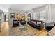 Bright living room featuring hardwood floors, a decorative rug, and comfortable furniture at 213 N Hesperides St, Tampa, FL 33609