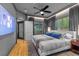 Primary bedroom with ample natural light, ceiling fan, and hardwood floors at 213 N Hesperides St, Tampa, FL 33609