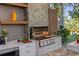 Outdoor kitchen features a Blaze grill, custom cabinets, and marble countertops for seamless meal preparation at 213 N Hesperides St, Tampa, FL 33609