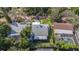 Aerial view of a well-maintained home with a screened-in patio, mature trees, and lush landscaping at 2134 Serpentine S Cir, St Petersburg, FL 33712