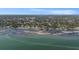 Breathtaking aerial view of waterfront homes with cityscape skyline in the distance and serene emerald water at 2134 Serpentine S Cir, St Petersburg, FL 33712