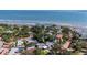 Aerial view of a beautiful house by the beach with a pool and lush green surroundings at 2134 Serpentine S Cir, St Petersburg, FL 33712