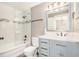 The updated bathroom features tile floors and tub with a glass shower door at 2134 Serpentine S Cir, St Petersburg, FL 33712