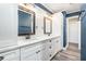 The updated bathroom features dual sinks, updated lighting, and a shiplap accent wall at 2134 Serpentine S Cir, St Petersburg, FL 33712
