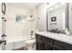 This cozy bathroom features a tile tub and shower with dark hardware at 2134 Serpentine S Cir, St Petersburg, FL 33712