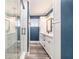 This bathroom features a glass shower, white cabinets, and neutral paint at 2134 Serpentine S Cir, St Petersburg, FL 33712
