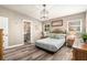 Comfortable bedroom with hardwood floors, side tables, and a quaint chandelier at 2134 Serpentine S Cir, St Petersburg, FL 33712