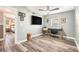 Modern bedroom showcasing sleek ceiling fan, work desk, and views into an adjacent room at 2134 Serpentine S Cir, St Petersburg, FL 33712
