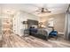 Bedroom features a large bed, ceiling fan and large mirror at 2134 Serpentine S Cir, St Petersburg, FL 33712