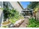Inviting courtyard featuring stone pavers, fountain, garden, and covered seating area perfect for relaxation at 2134 Serpentine S Cir, St Petersburg, FL 33712