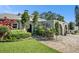 Landscaped walkway leading to a lovely home with a charming arched entryway and well-maintained lawn at 2134 Serpentine S Cir, St Petersburg, FL 33712