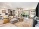 Spacious living room with hardwood floors, stylish furniture, and sliding glass doors to the patio at 2134 Serpentine S Cir, St Petersburg, FL 33712