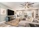 Open living area with modern decor, wood floors, and a large TV for entertainment at 2134 Serpentine S Cir, St Petersburg, FL 33712