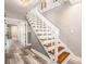 Staircase featuring hardwood steps, white risers, and access to an adjacent hallway at 2134 Serpentine S Cir, St Petersburg, FL 33712