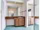 Bathroom with vintage-style wooden cabinets and large mirrors at 2217 High Point Dr, Brandon, FL 33511