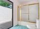 Bathroom featuring toilet, frosted shower, and access to deck at 2217 High Point Dr, Brandon, FL 33511