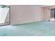Spacious bedroom with sliding doors to balcony and pastel green carpet at 2217 High Point Dr, Brandon, FL 33511