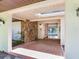 Covered front entrance with red tiled patio and stone accent wall at 2217 High Point Dr, Brandon, FL 33511