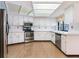 Updated kitchen with white cabinetry, stainless steel appliances, and skylight providing natural light at 2217 High Point Dr, Brandon, FL 33511