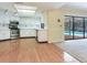 Bright kitchen with stainless appliances and breakfast bar has a view of the pool through sliding glass doors at 2217 High Point Dr, Brandon, FL 33511