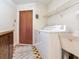 Laundry room featuring washer, dryer, and utility sink at 2217 High Point Dr, Brandon, FL 33511