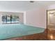 Living room with large sliding glass doors overlooking pool area and wooden floors at 2217 High Point Dr, Brandon, FL 33511