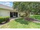 Home's backyard features lawn with landscaping and patio with outdoor seating at 2403 Nantucket Field Way # 27, Sun City Center, FL 33573