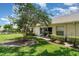 The backyard boasts a well-manicured lawn, landscaped yard, and patio at 2403 Nantucket Field Way # 27, Sun City Center, FL 33573