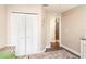 Bedroom featuring a closet with bi-fold doors and view to hall at 2403 Nantucket Field Way # 27, Sun City Center, FL 33573