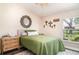 Cozy bedroom with a large window, natural light, and decorative wall art at 2403 Nantucket Field Way # 27, Sun City Center, FL 33573